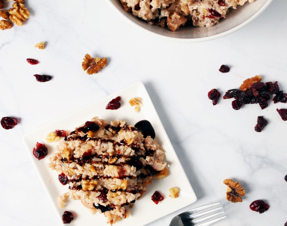 angled view of instant pot apple cider cranberry risotto on square plate 1