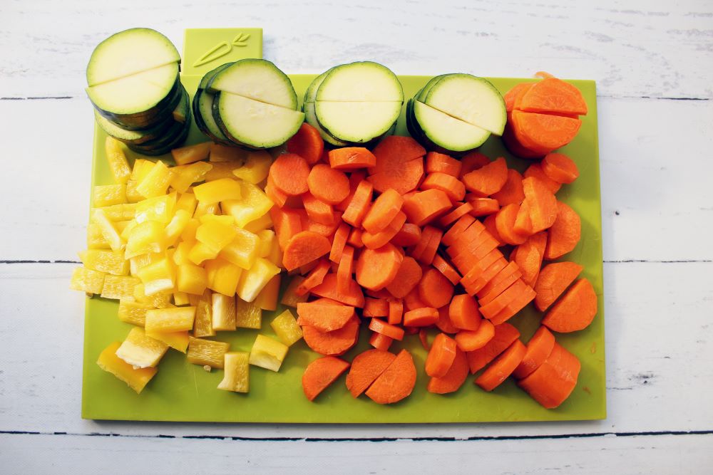 veggies on cutting board for turmeric chicken skillet 1