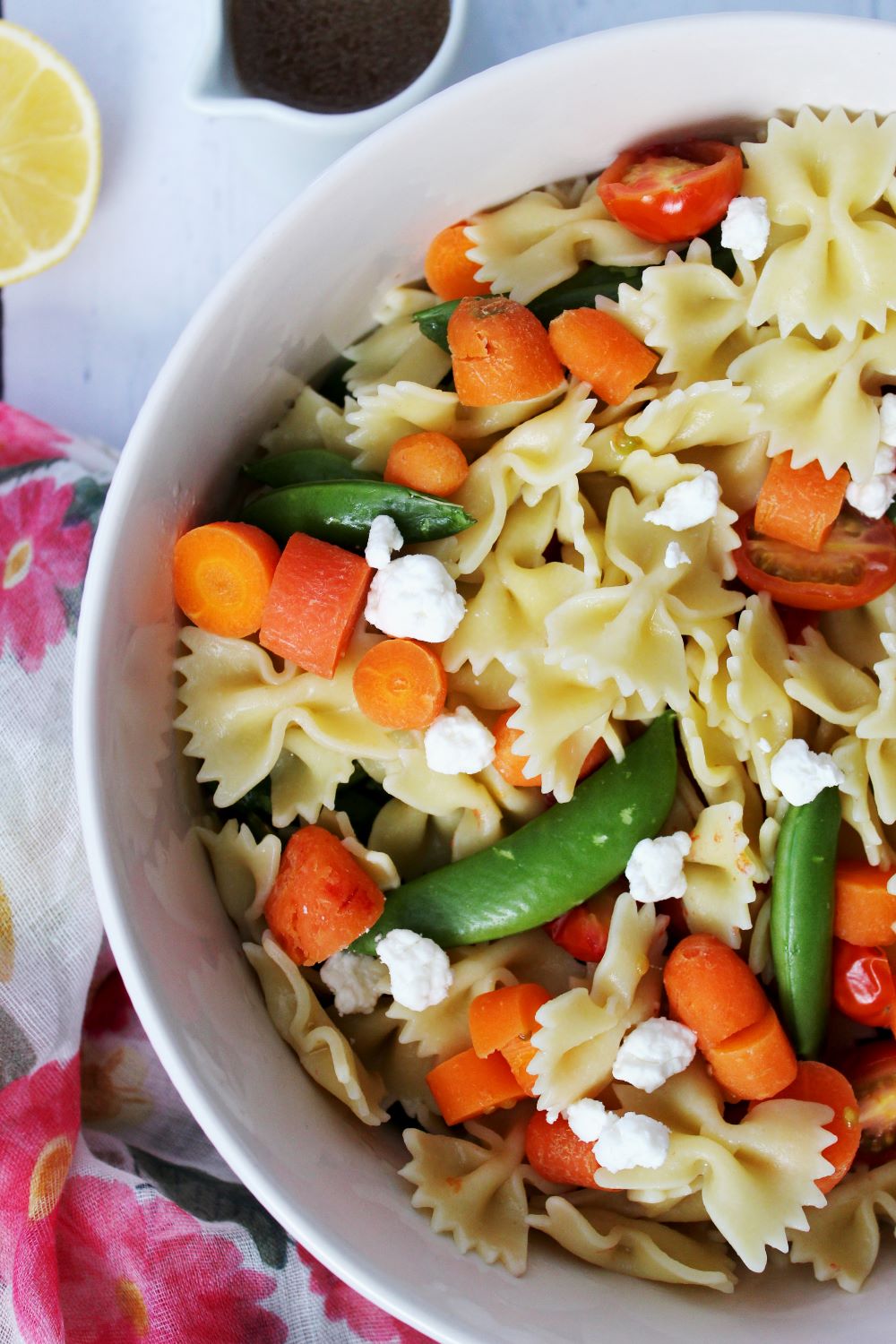 lemon basil pasta salad with foral tea towel and dressing 1