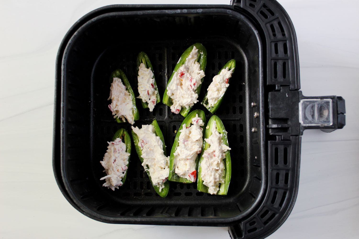 stuffed jalapenos in air fryer basket 1