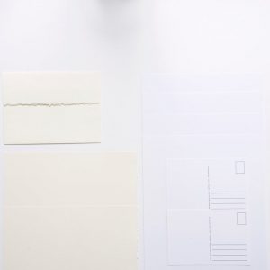 flatlay of water color paper mixed pack with cards and postcards