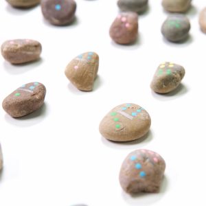 close up of finished painted rock domino set