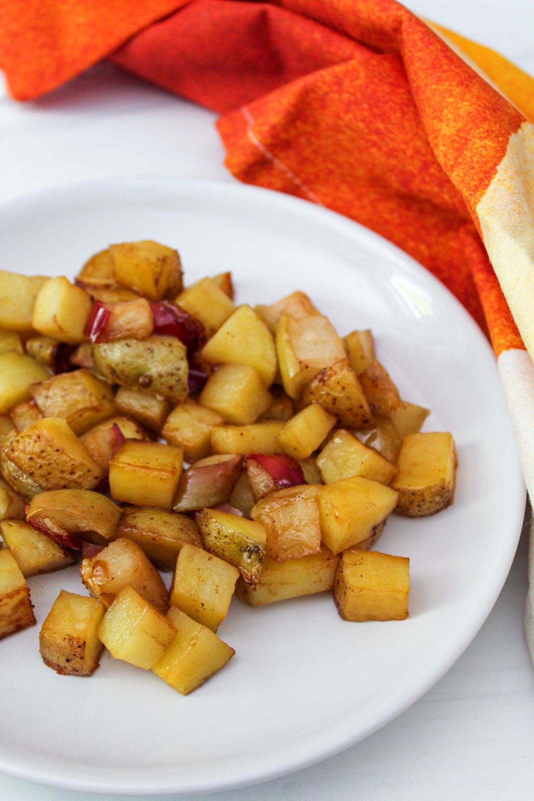 honey chipotle roasted potatoes and apples on vertical plate 1