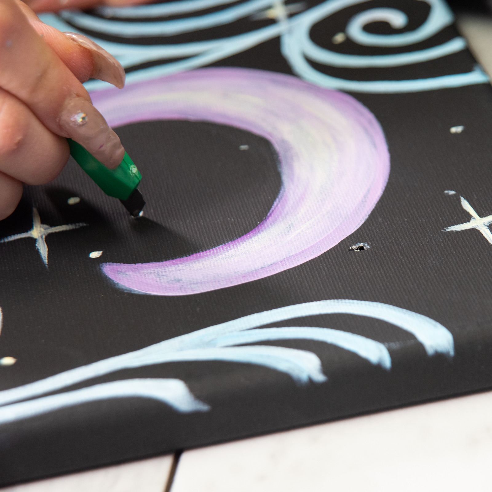 make holes in the canvas to add fairy lights