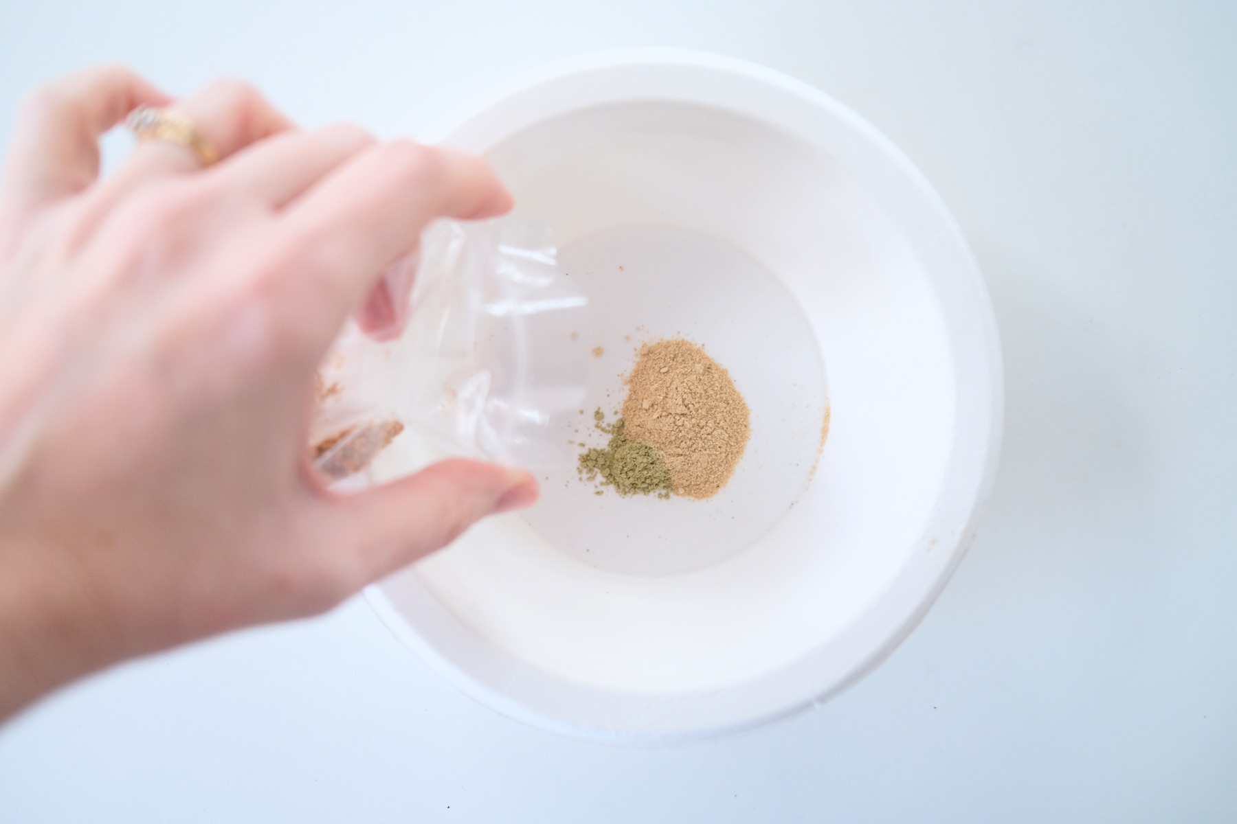 pour a small amount of herbs into the bowl
