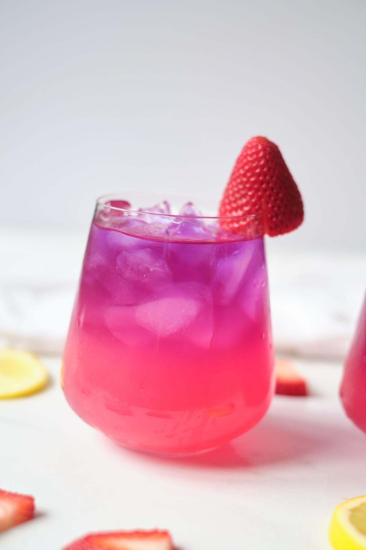 butterfly pea and strawberry lemonade with a garnish