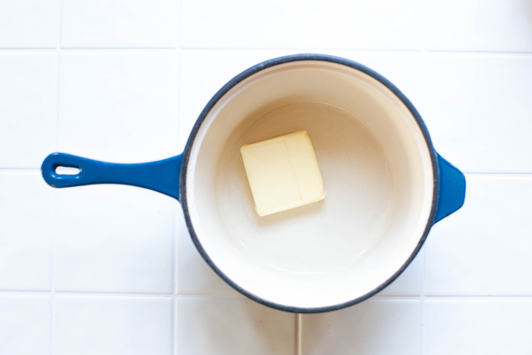 add butter to a pan for cap'n crunch marshmallow treats