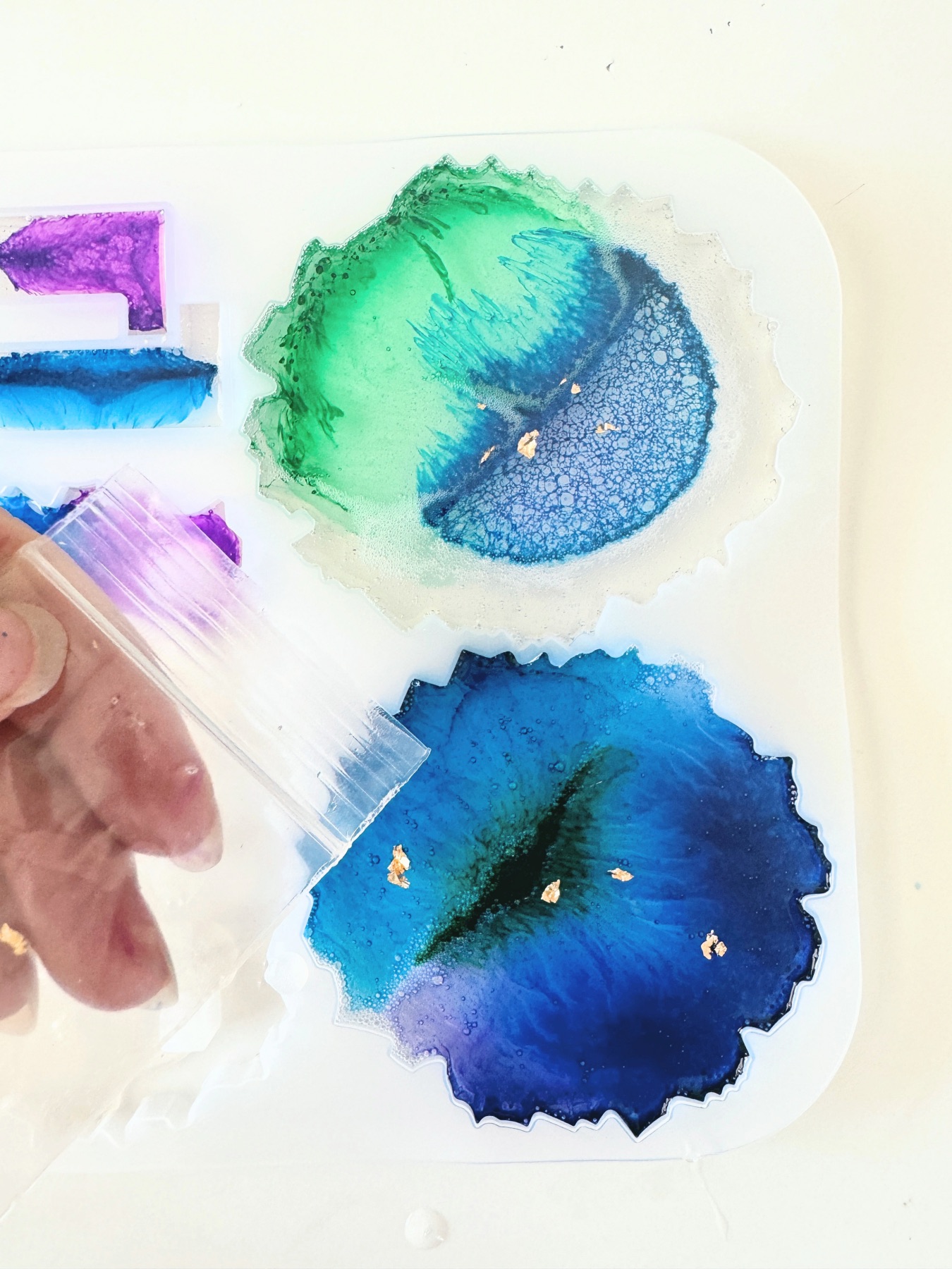 add metallic flecks to the resin before it sets