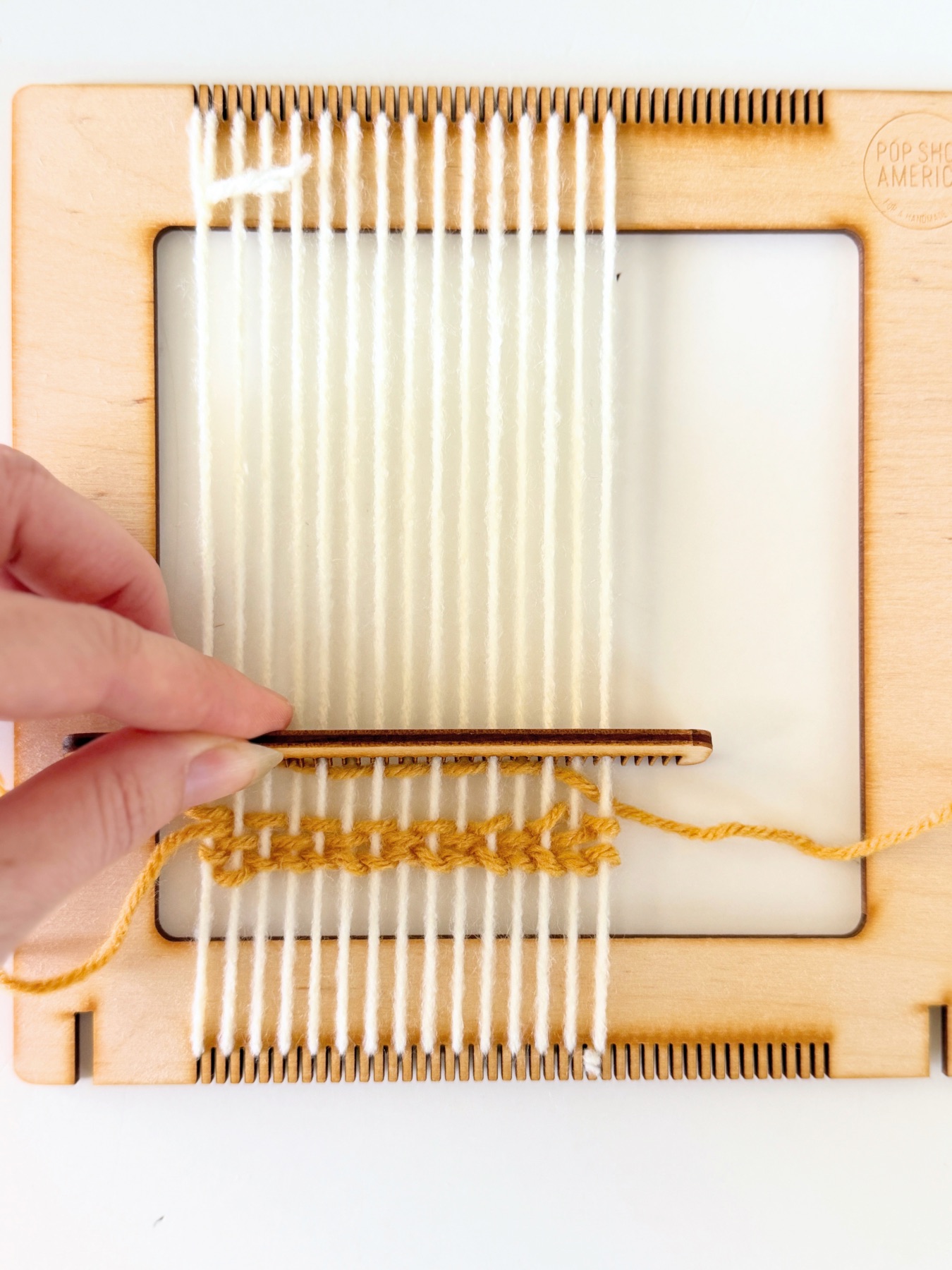 move the yarn into place with a comb web