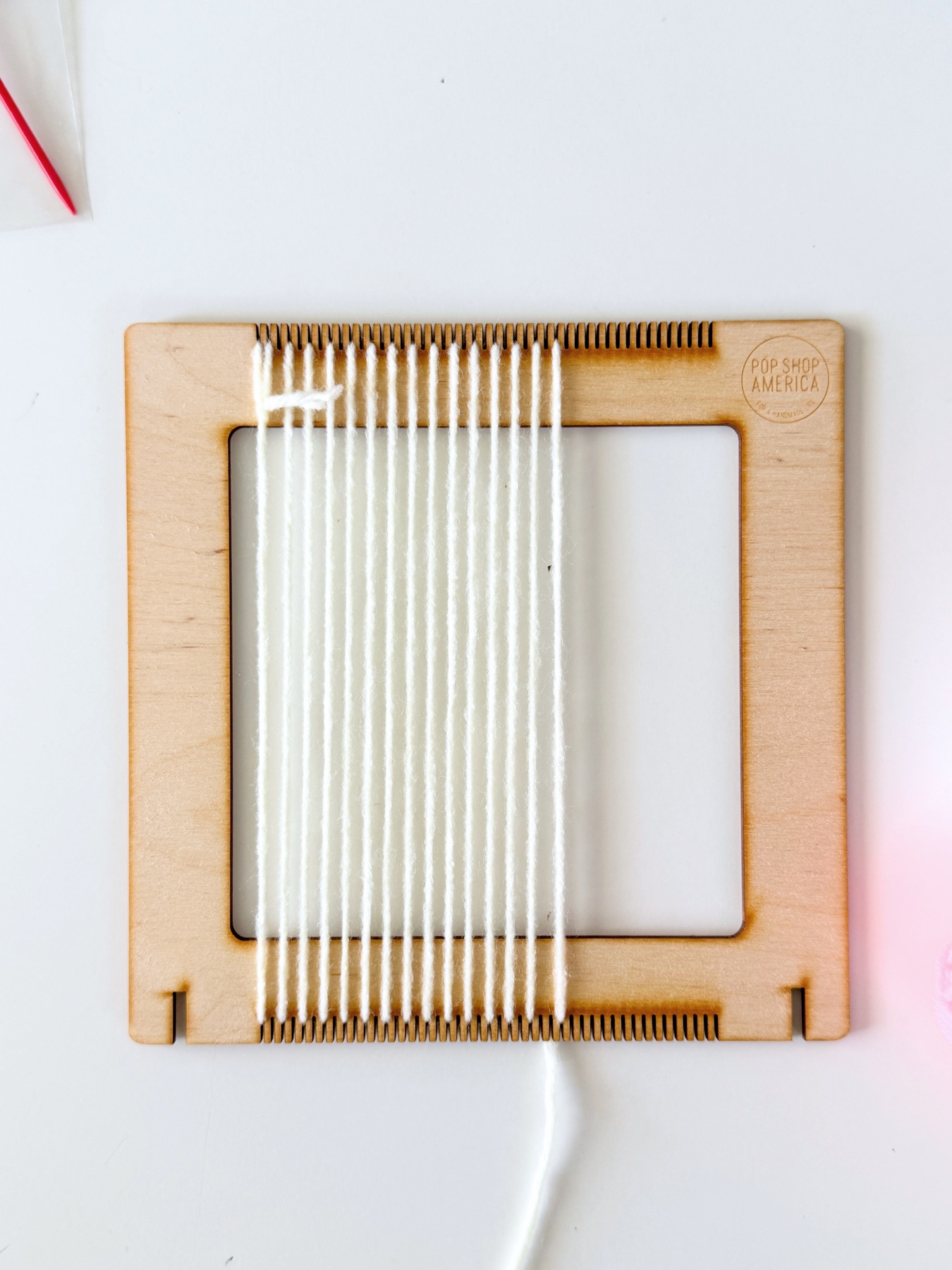 threaded loom ready to weave web