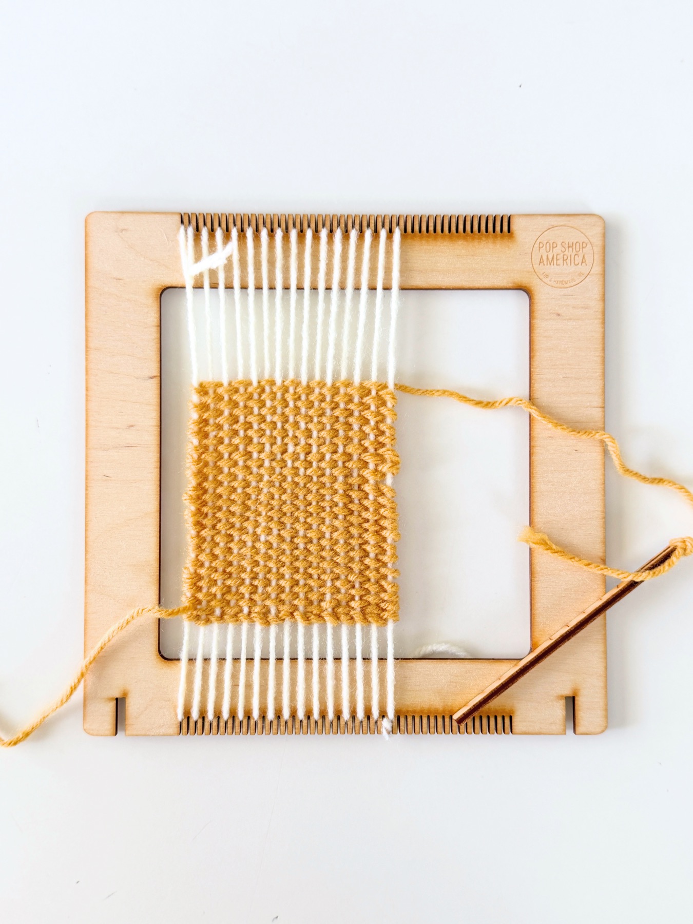 woven coaster still on the loom web