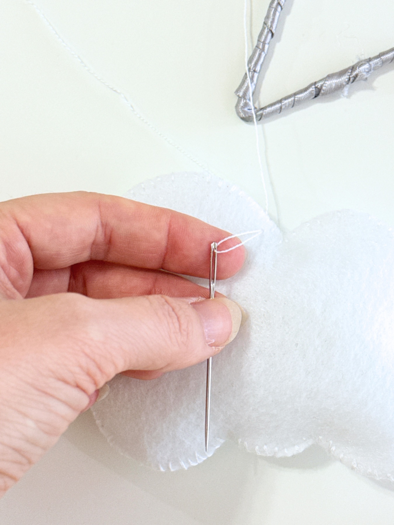 use one string to attach the felt plushies to the star web