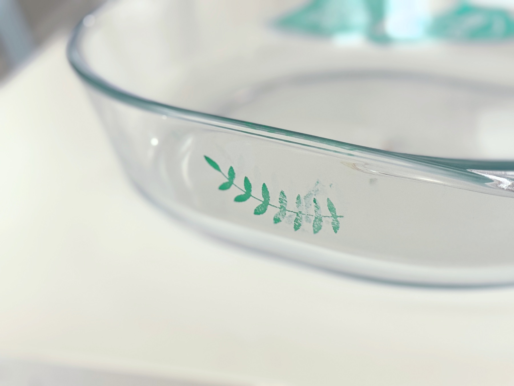 close up of ivy stenciled on glass bakeware